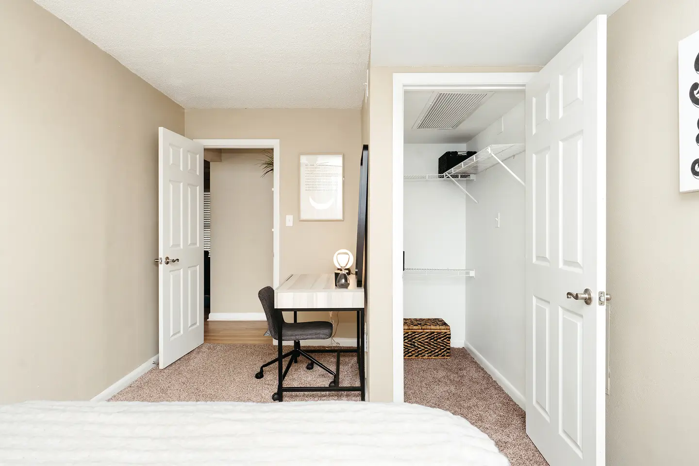 Bedroom with a spacious closet and desk.
